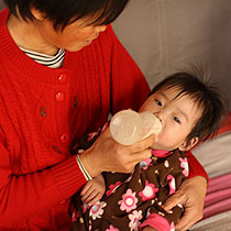 Orphans at New Hope foundation drinking formula provided by PFO